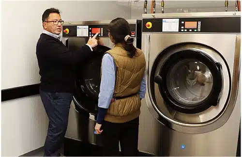 An Aqualogic consultant training laundry staff on site